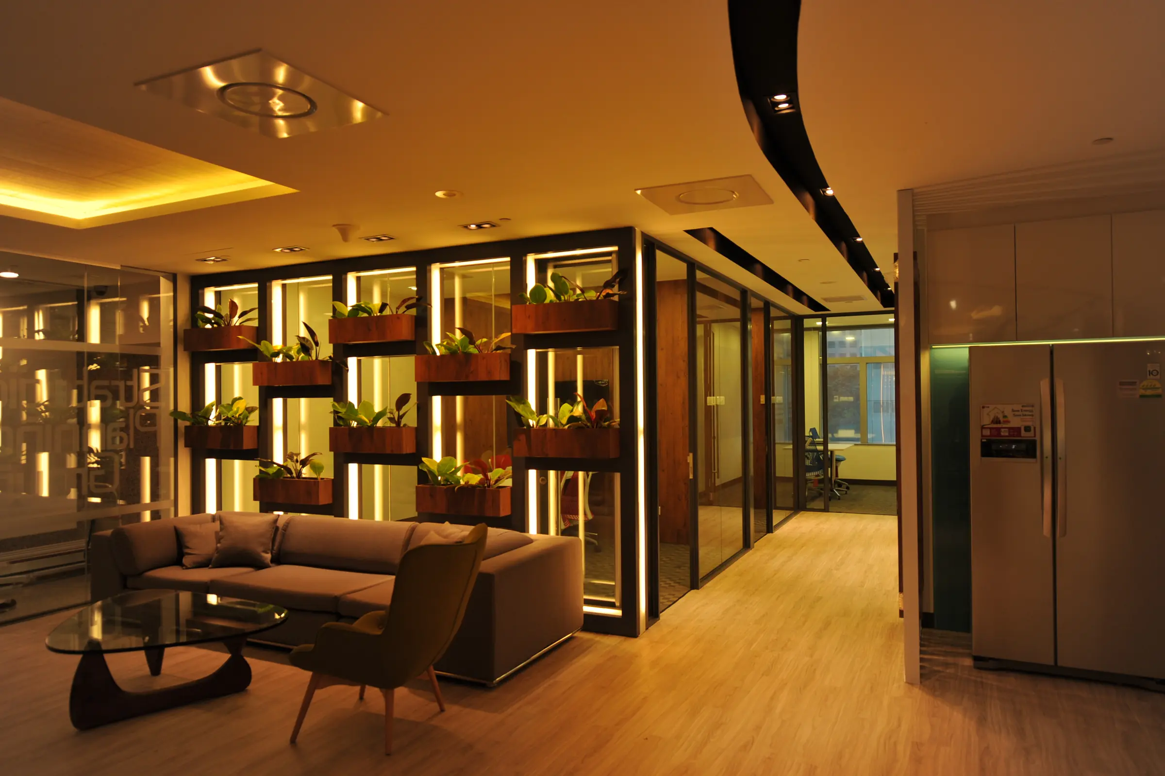 Workplace lounge with planted shelving